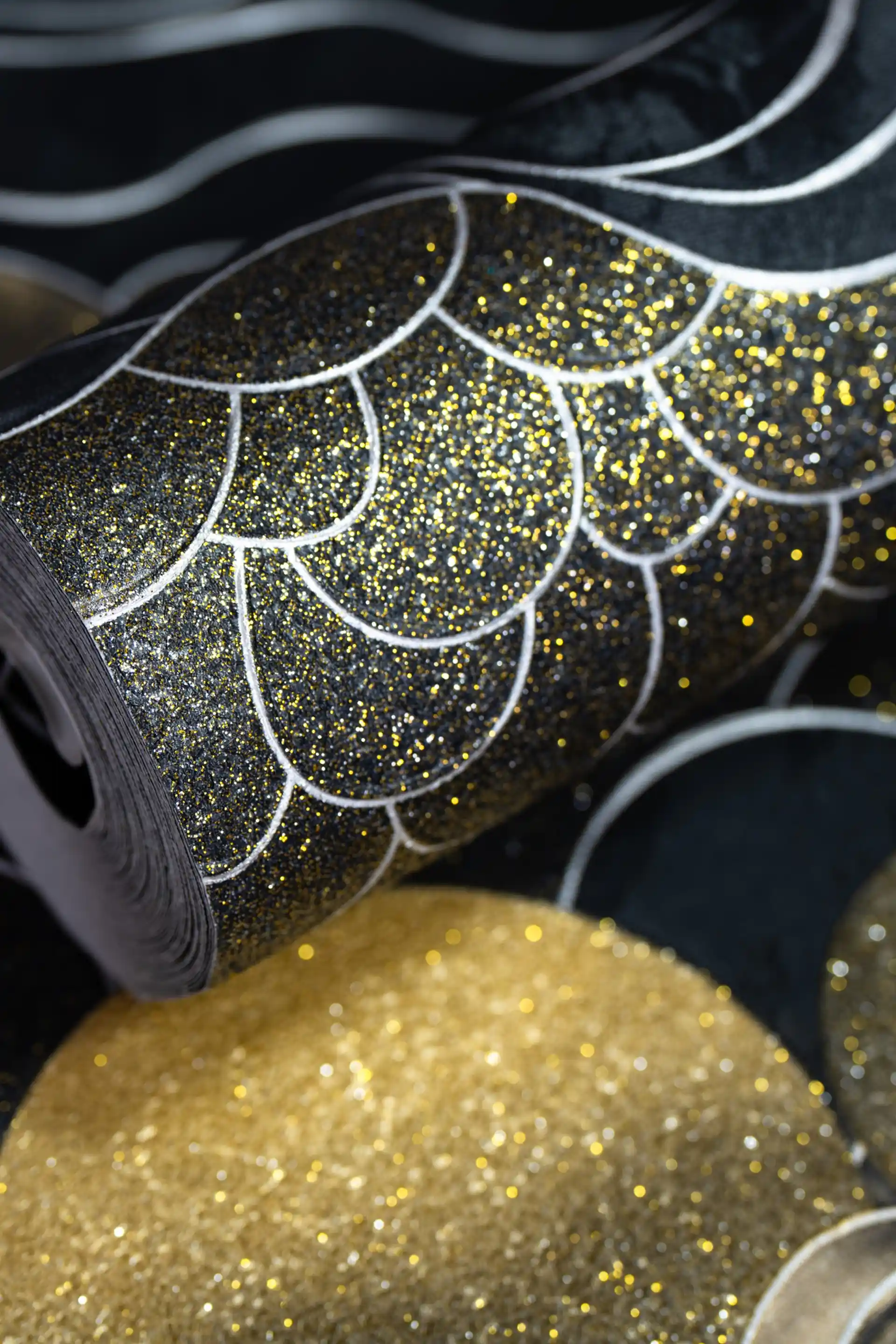Black wallpaper roll with abstract cloud scales, golden suns, and silver wave patterns with glitter accents